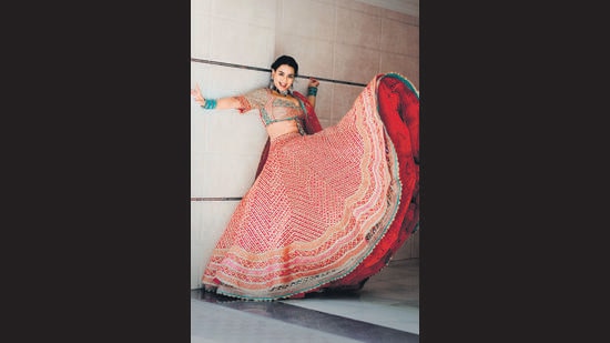 This silk and tulle lehenga by Rimple and Harpreet Narula with multihued border saves from the monotony of red.