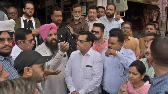 Shopkeepers objecting to road level as MLA Madan Lal Bagga reached Chander Nagar area for inaugurating road construction work in Ludhiana on March 31, 2022. (HT PHOTO)