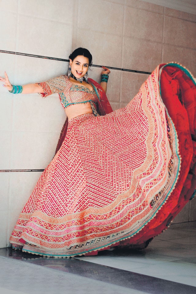 This silk and tulle lehenga by Rimple and Harpreet Narula with multihued border saves from the monotony of red. This silk and tulle lehenga by Rimple and Harpreet Narula with multihued border saves from the monotony of red.