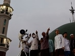 Muslim men look for the position of the moon to mark the first day of the holy fasting month of Ramadan on the roof of Al-Musyari'in mosque in Jakarta, Indonesia, April 1, 2022.&nbsp;