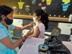 A healthcare worker administers a dose of the Covid-19 vaccine to a student in the age group of 12-14 years. (PTI) A healthcare worker administers a dose of the Covid-19 vaccine to a student in the age group of 12-14 years. (PTI)