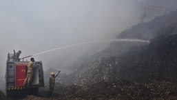 Firefighters douse a fire at the Ghazipur landfill site on Tuesday.&nbsp;