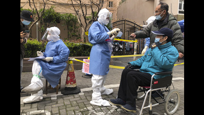 Workers in protective gear register residents for the first round of mass Covid testing in the Jingan district of western Shanghai, China, on Friday. (AP) Workers in protective gear register residents for the first round of mass Covid testing in the Jingan district of western Shanghai, China, on Friday. (AP)