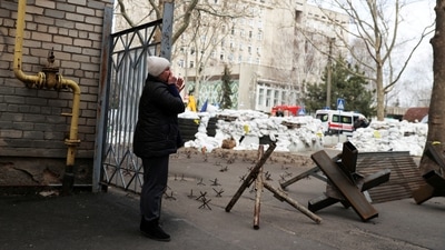 A woman cries as she waits for news of her relative, in front of a destroyed Ukrainian government administration building following a bombing, as Russia's invasion of Ukraine continues, in Mykolaiv, Ukraine, (REUTERS)