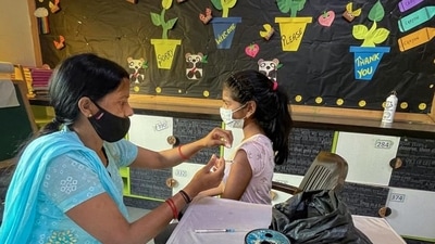 A healthcare worker administers a dose of the Covid-19 vaccine to a student in the age group of 12-14 years. (PTI)