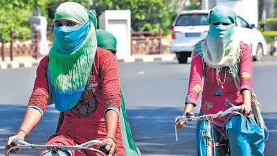 Women cycling with their faces covered amid the sweltering weather in Chandigarh’s Sector 8 on Friday. As per IMD forecast, April is also set to see above normal temperatures. (Keshav Singh/HT) Women cycling with their faces covered amid the sweltering weather in Chandigarh’s Sector 8 on Friday. As per IMD forecast, April is also set to see above normal temperatures. (Keshav Singh/HT)