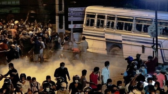 Demonstrators move away from tear gas used by the police near Sri Lankan President Gotabaya Rajapaksa's residence during a protest against him as many parts of the crisis-hit country faced up to 13 hours without electricity due to a shortage of foreign currency to import fuel, in Colombo. (Reuters)