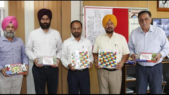 Officials of PAU with the ludo game, developed by the university, in Ludhiana on April 1, 2022. (HT PHOTO)