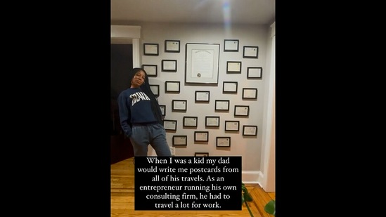 The image, taken from the Instagram video, shows the woman standing in front of the postcards she received from her father. (Instagram/@lauren.rosa.miller)