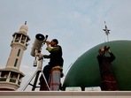 Muslim men look for the position of the moon to mark the first day of the holy fasting month of Ramadan on the roof of Al-Musyari'in mosque in Jakarta, Indonesia&nbsp;