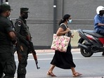 A pedestrian walks past soldiers standing on guard along a street in Colombo on April 2, 2022. (Photo by Ishara S. KODIKARA / AFP)(AFP) A pedestrian walks past soldiers standing on guard along a street in Colombo on April 2, 2022. (Photo by Ishara S. KODIKARA / AFP)(AFP)
