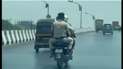 The grab from a 40-second video that went viral in which police personnel were riding triples on a two-wheeler, thus violating traffic rules, on the Mumbai-Pune Highway. The Navi Mumbai traffic police have levied a fine on the rider. (HT PHOTO) The grab from a 40-second video that went viral in which police personnel were riding triples on a two-wheeler, thus violating traffic rules, on the Mumbai-Pune Highway. The Navi Mumbai traffic police have levied a fine on the rider. (HT PHOTO)