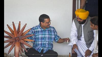 Delhi CM Arvind Kejriwal and Punjab CM Bhagwant Mann spin thread in a ‘charkha’ during their visit to Gandhi Ashram, in Ahmedabad, Saturday. (PTI) Delhi CM Arvind Kejriwal and Punjab CM Bhagwant Mann spin thread in a ‘charkha’ during their visit to Gandhi Ashram, in Ahmedabad, Saturday. (PTI)