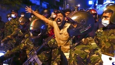 A Sri Lankan man shouts anti government slogans during a protest outside Sri Lankan president's private residence on the outskirts of Colombo, Sri Lanka, (AP) A Sri Lankan man shouts anti government slogans during a protest outside Sri Lankan president's private residence on the outskirts of Colombo, Sri Lanka, (AP)
