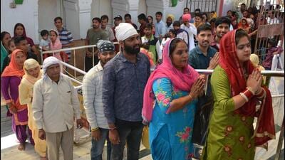 Devotees lined up to pay obeisance on the first day of the Chaitra Navratri Mela at Mata Mansa Devi Temple in Panchkula on Saturday. (Sant Arora/HT)