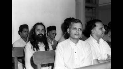 Godse (left in row one) in the dock along with ND Apte (right in row one) and other co-accused, including Savarkar (extreme right in the back row), on teh first day of the trial in the special court at Red Fort on 27 May 1948. (Photo Division, PIB, Government of India)