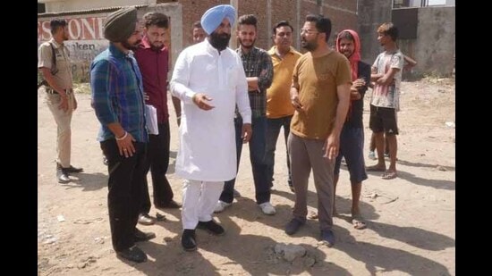AAP MLA Kulwant Sidhu, along with MC officials, inspecting the work to remove garbage from an open plot near Model Town Extension in Ludhiana on Saturday. (HT Photo)