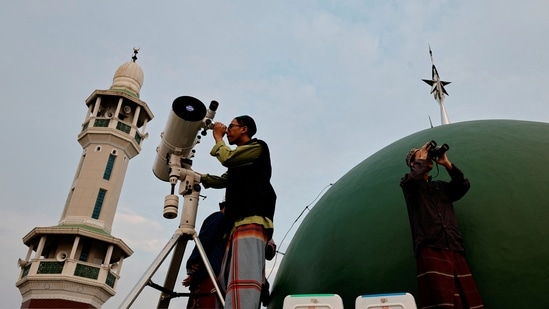 Muslim men look for the position of the moon to mark the first day of the holy fasting month of Ramadan on the roof of Al-Musyari'in mosque in Jakarta, Indonesia&nbsp;