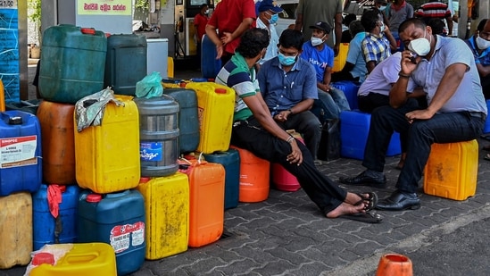 People wait in a queue to buy diesel at a Ceylon Petroleum Corporation fuel station in Colombo on March 31, 2022.&nbsp;(AFP)