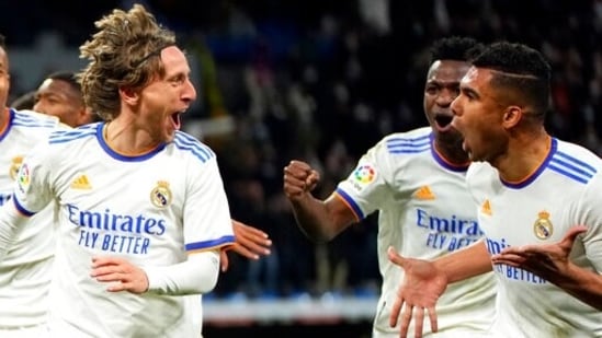 Real Madrid's Luka Modric, left, celebrates with teammate Mariano Diaz after scoring during the Spanish La Liga soccer match between Real Madrid and Real Sociedad.(AP)