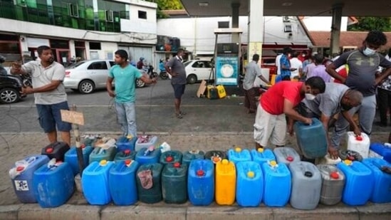 Sri Lankans gather at a fuel station to buy diesel before the beginning of curfew in Colombo, Sri Lanka, Saturday.&nbsp;((AP Photo/Eranga Jayawardena))