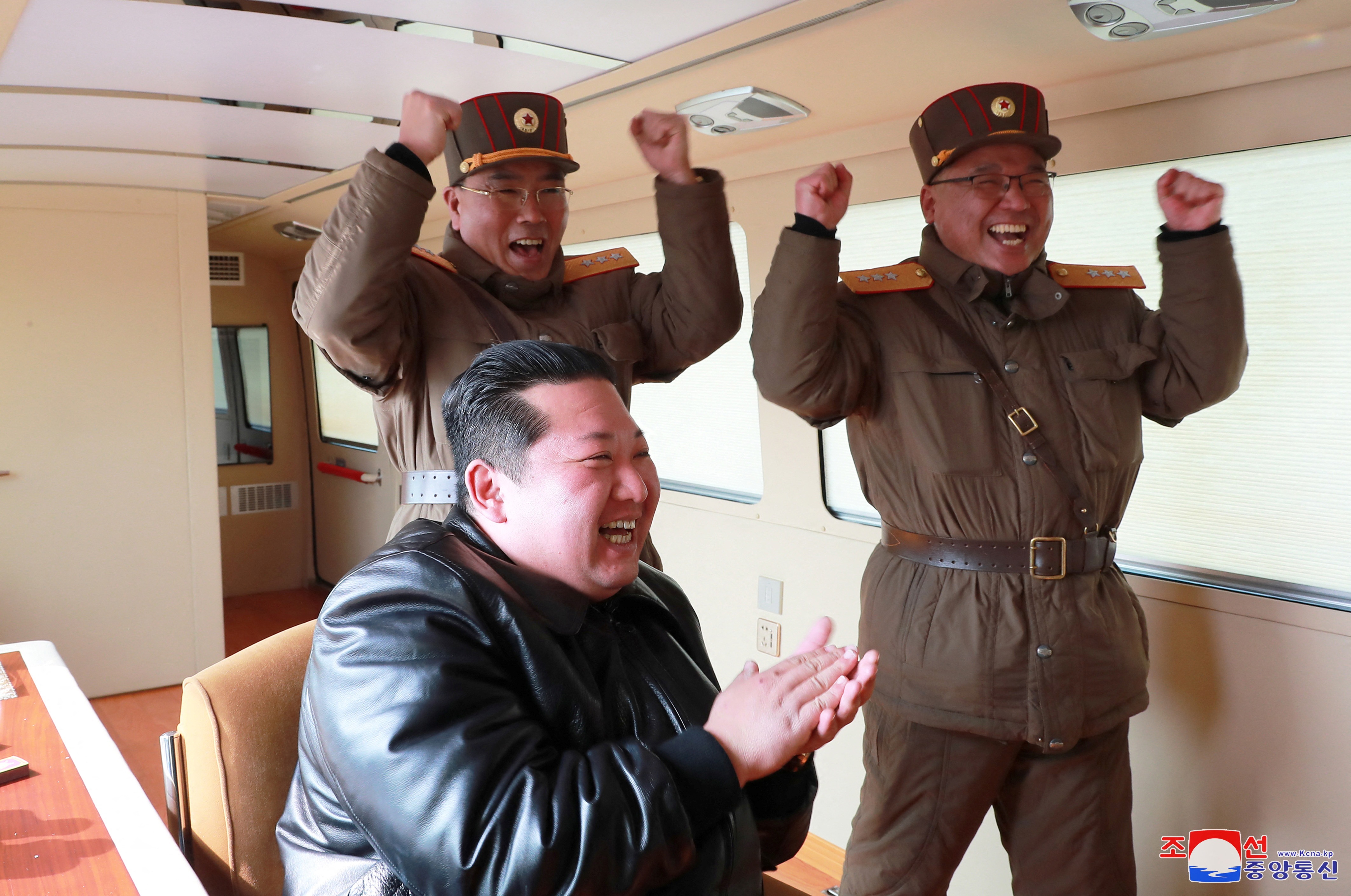 North Korean leader Kim Jong Un reacts next to military officials during what state media reports is the launch of the "Hwasong-17" intercontinental ballistic missile (ICBM) in this undated photo released on March 25, 2022 by North Korea's Korean Central News Agency (KCNA).&nbsp; (via REUTERS)