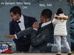 A woman takes a photo of a mural by Berlin-based street artist Eme Freethinker featuring the likeness of US actor Will Smith (R) slapping US comedian Chris Rock during the Oscars ceremony, in Berlin. A woman takes a photo of a mural by Berlin-based street artist Eme Freethinker featuring the likeness of US actor Will Smith (R) slapping US comedian Chris Rock during the Oscars ceremony, in Berlin.