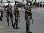 Sri Lankan army soldiers stand guard at a checkpoint after the government imposed a curfew following a clash between police and protestors near Sri Lankan President Gotabaya Rajapaksa's residence during a protest last Thursday, amid the country's economic crisis, in Colombo, Sri Lanka.
