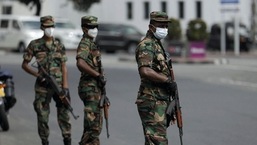 Sri Lankan army soldiers stand guard at a checkpoint after the government imposed a curfew following a clash between police and protestors near Sri Lankan President Gotabaya Rajapaksa's residence during a protest last Thursday, amid the country's economic crisis, in Colombo, Sri Lanka.