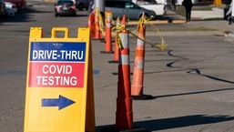 FILE - A sign points to a COVID testing site at the Cincinnati Veterans Affairs Medical Center in Cincinnati,