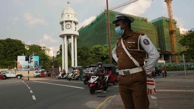 Colombo: A Sri Lankan police officer stands in a street as curfew begins in Colombo, Sri Lanka, (AP) Colombo: A Sri Lankan police officer stands in a street as curfew begins in Colombo, Sri Lanka, (AP)