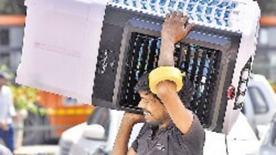 A man carries an air cooler at Kamla Market, in New Delhi on Sunday. (Sanjeev Verma/HT PHOTO)