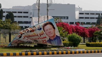 A billboard with the picture of Pakistan's Prime Minister Imran Khan is displayed outside the National Assembly, in Islamabad. A billboard with the picture of Pakistan's Prime Minister Imran Khan is displayed outside the National Assembly, in Islamabad.