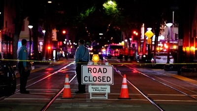 A roadblock is set a block away from the scene of a mass shooting in Sacramento. (AP) A roadblock is set a block away from the scene of a mass shooting in Sacramento. (AP)