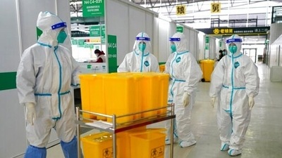 Medical workers in protective suits walk at the Shanghai New International Expo Center, which has been converted to a quarantine facility for people with mild and asymptomatic cases of Covid-19, in Shanghai. (AP) Medical workers in protective suits walk at the Shanghai New International Expo Center, which has been converted to a quarantine facility for people with mild and asymptomatic cases of Covid-19, in Shanghai. (AP)