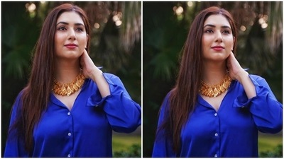 Disha slipped into a trendy look for the photoshoot. The Bade Achhe Lagte Hain 2 actor wore a silk satin bright blue button-down collared shirt featuring long sleeves and a curved hemline. She teamed it with a pair of distressed denim shorts with a frayed hem and mini hem length, and for accessories, Disha opted for a chunky gold necklace. (Instagram/@dishaparmar) Disha slipped into a trendy look for the photoshoot. The Bade Achhe Lagte Hain 2 actor wore a silk satin bright blue button-down collared shirt featuring long sleeves and a curved hemline. She teamed it with a pair of distressed denim shorts with a frayed hem and mini hem length, and for accessories, Disha opted for a chunky gold necklace. (Instagram/@dishaparmar)