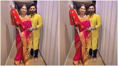 While Disha wore a pink and yellow silk saree with a matching blouse for the occasion, Rahul complemented her in a yellow embroidered kurta and black pants. Disha styled her look with a sleek bun, traditional nath, earrings, bangles, chain, mangalsutra, and minimal make-up. (Instagram/@dishaparmar) While Disha wore a pink and yellow silk saree with a matching blouse for the occasion, Rahul complemented her in a yellow embroidered kurta and black pants. Disha styled her look with a sleek bun, traditional nath, earrings, bangles, chain, mangalsutra, and minimal make-up. (Instagram/@dishaparmar)