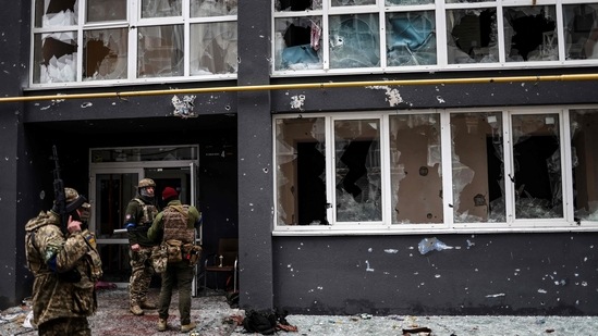 Ukranian soldiers patrol a street in Bucha, northwest of Kyiv, on April 2, 2022, where town's mayor said 280 people had been buried in a mass grave and that the town is littered with corpses.. (AFP)