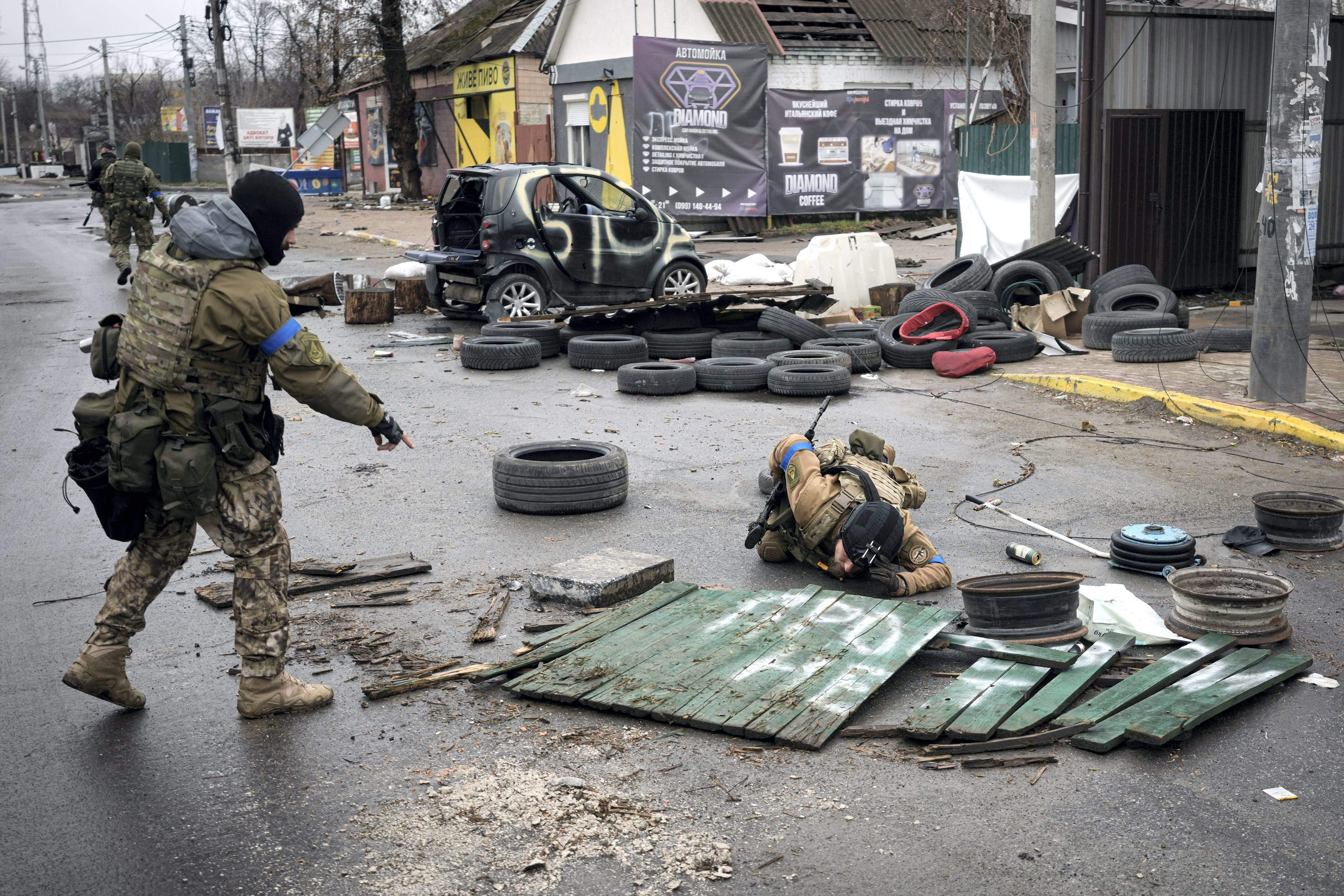 Ukrainian servicemen check streets for booby traps in the formerly Russian-occupied Kyiv suburb of Bucha. (AP)