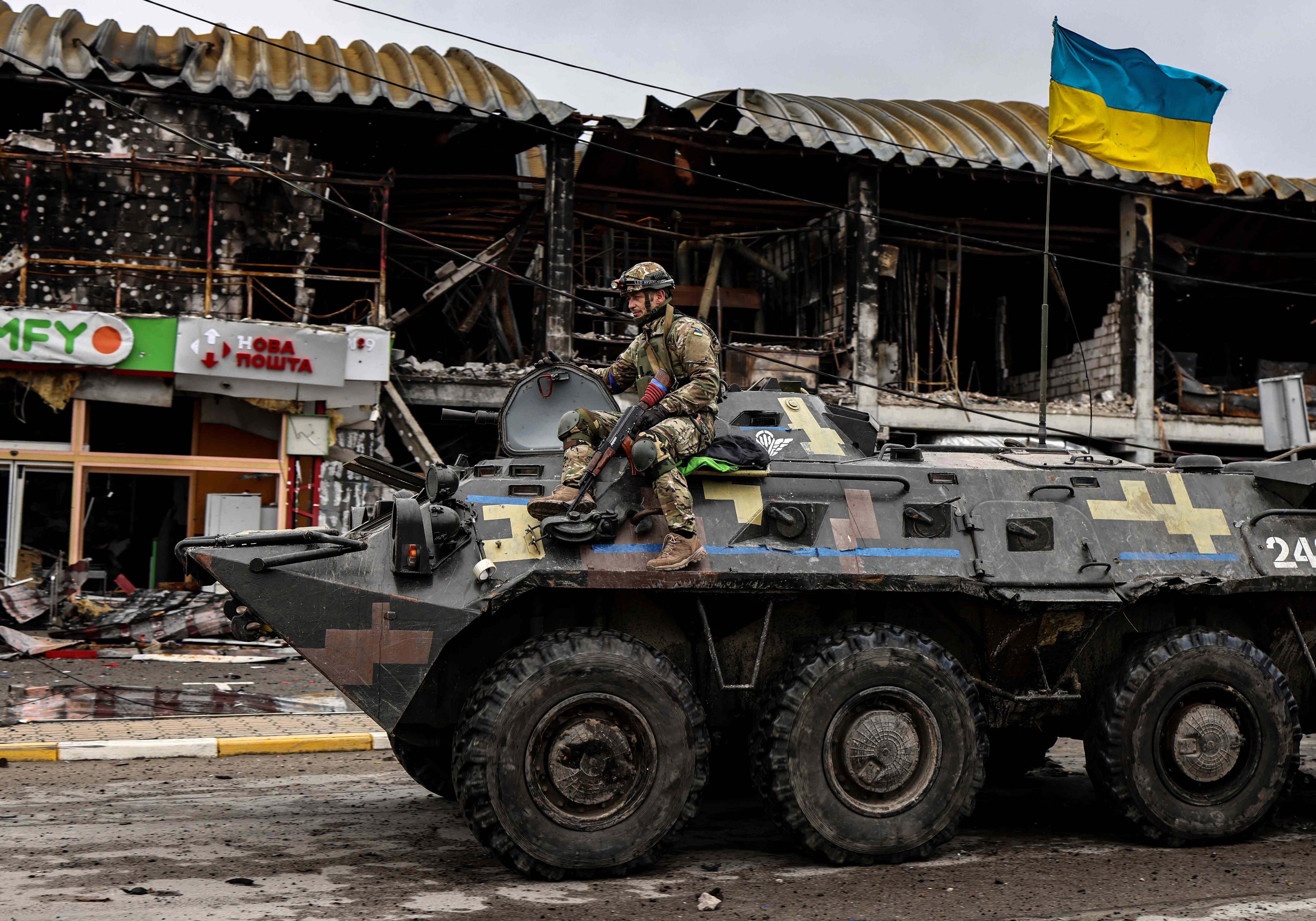 An Ukranian soldier patrols in an armoured vehicle a street in Bucha, northwest of Kyiv, on April 2, 2022, where town's mayor said 280 people had been buried in a mass grave and that the town is littered with corpses. (Photo by RONALDO SCHEMIDT/AFP) An Ukranian soldier patrols in an armoured vehicle a street in Bucha, northwest of Kyiv, on April 2, 2022, where town's mayor said 280 people had been buried in a mass grave and that the town is littered with corpses. (Photo by RONALDO SCHEMIDT/AFP)