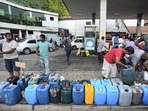 Sri Lankans gather at a fuel station to buy diesel before the beginning of curfew in Colombo, Sri Lanka. (AP)