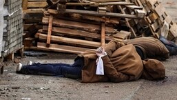 A body, with wrists tied behind their back, lies on a street in Bucha, just northwest of the capital Kyiv.