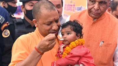 Uttar Pradesh Chief Minister Yogi Adityanath feeds an infant. (Pawan Kumar) Uttar Pradesh Chief Minister Yogi Adityanath feeds an infant. (Pawan Kumar)