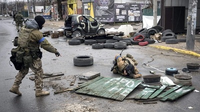 Ukrainian servicemen check streets for booby traps in the formerly Russian-occupied Kyiv suburb of Bucha. (AP)