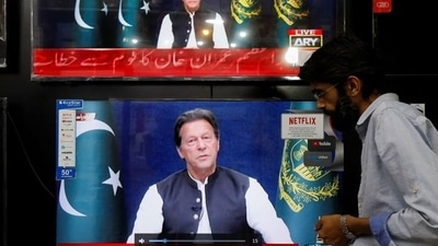 FILE PHOTO: A shopkeeper tunes a television screen to watch the speech of Pakistani Prime Minister Imran Khan, at his shop in Islamabad,&nbsp; (REUTERS)