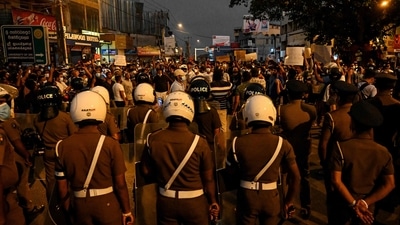 Police stood guard as protests erupted against the surge in prices and shortage of fuel and other essential commodities in Colombo. (AFP) Police stood guard as protests erupted against the surge in prices and shortage of fuel and other essential commodities in Colombo. (AFP)