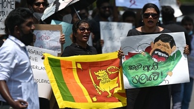 Protestors hold banners and placards during a demonstration against the surge in prices and shortage of fuel and other essential commodities in Colombo on Monday. (AFP) Protestors hold banners and placards during a demonstration against the surge in prices and shortage of fuel and other essential commodities in Colombo on Monday. (AFP)