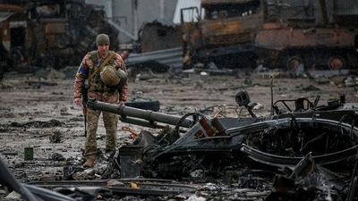 A Ukrainian service member inspects a compound of the Antonov airfield, in Kyiv region, Ukraine. (REUTERS)