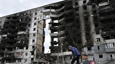 A man walks past destroyed buildings in the town of Borodianka, northwest of Kyiv. (AFP)