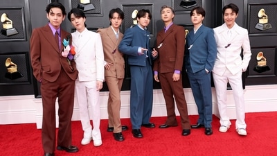 BTS members V, Suga, Jin, Jungkook, RM, Jimin and J-Hope won the night with their dapper Louis Vuitton suits. They coordinated their outfits in brown, white, tan and slate blue shades with embellished floral pins. (AFP) BTS members V, Suga, Jin, Jungkook, RM, Jimin and J-Hope won the night with their dapper Louis Vuitton suits. They coordinated their outfits in brown, white, tan and slate blue shades with embellished floral pins. (AFP)